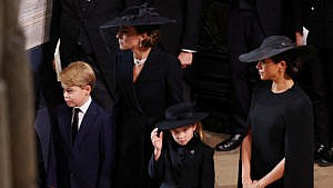 Kate, Meghan, Prince George and Princess Charlotte stand inside Westminster Abbey during the Queen's funeral.