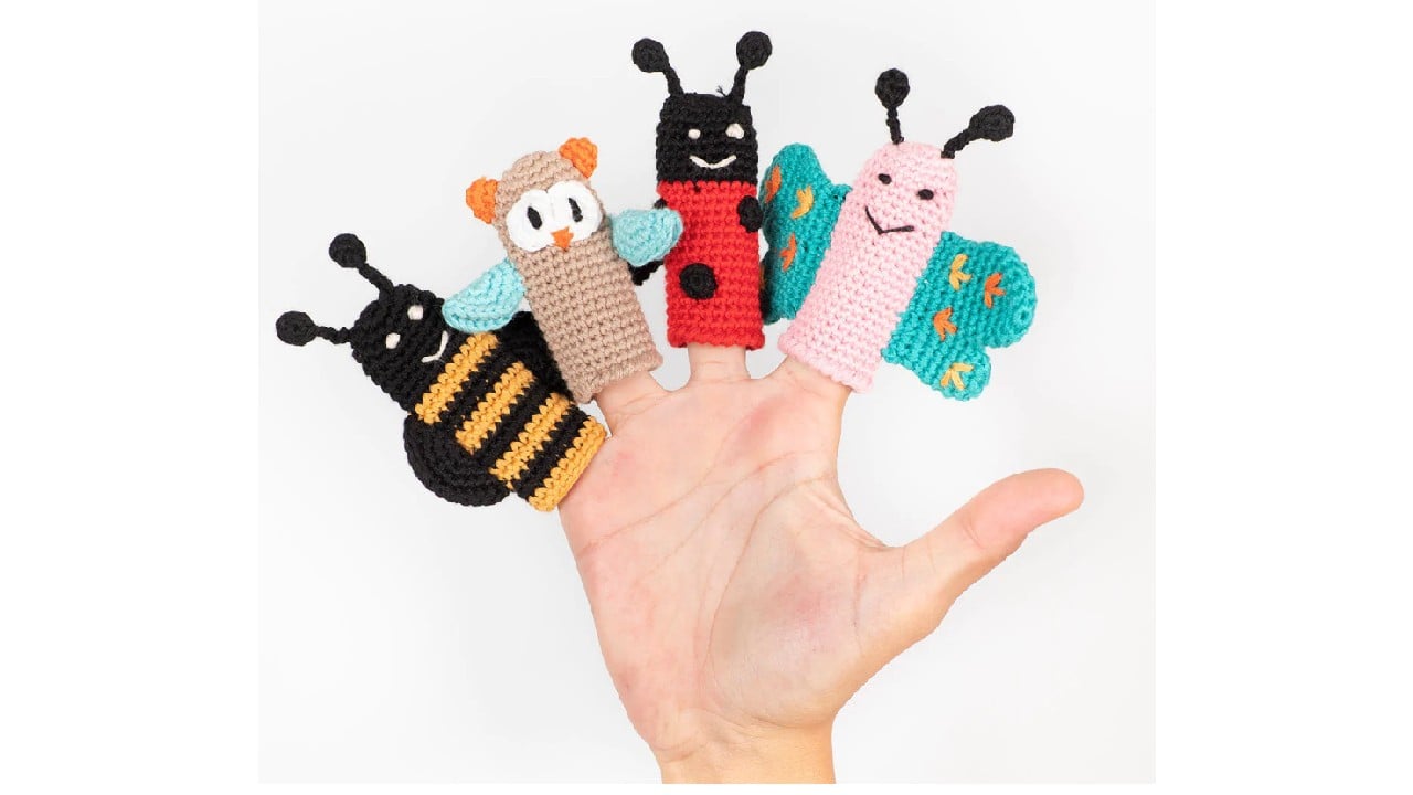 hand with knit insect finger puppets