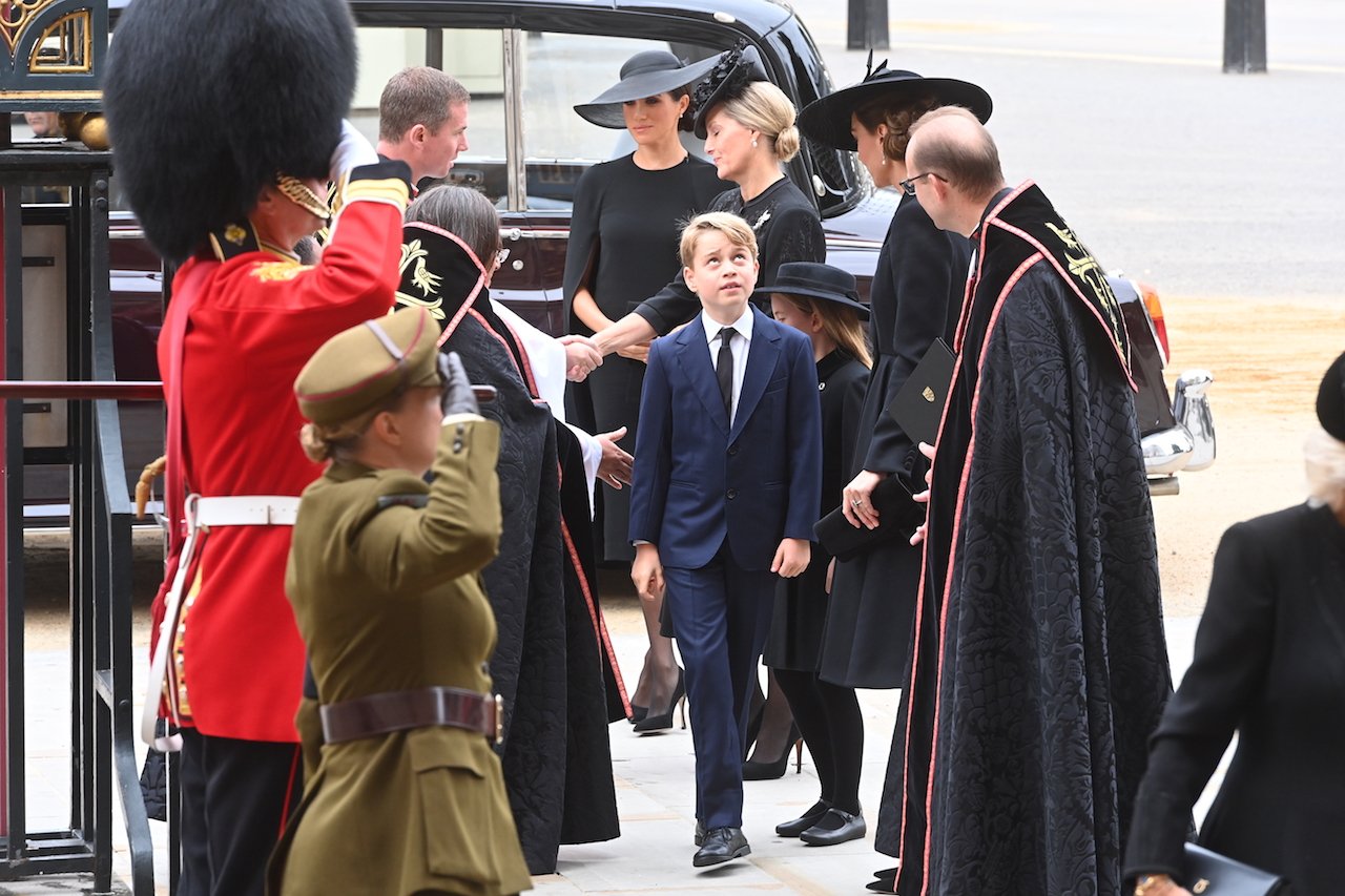 Prins George tittar på Westminster Abbey utanför sin gammelmormors begravning.