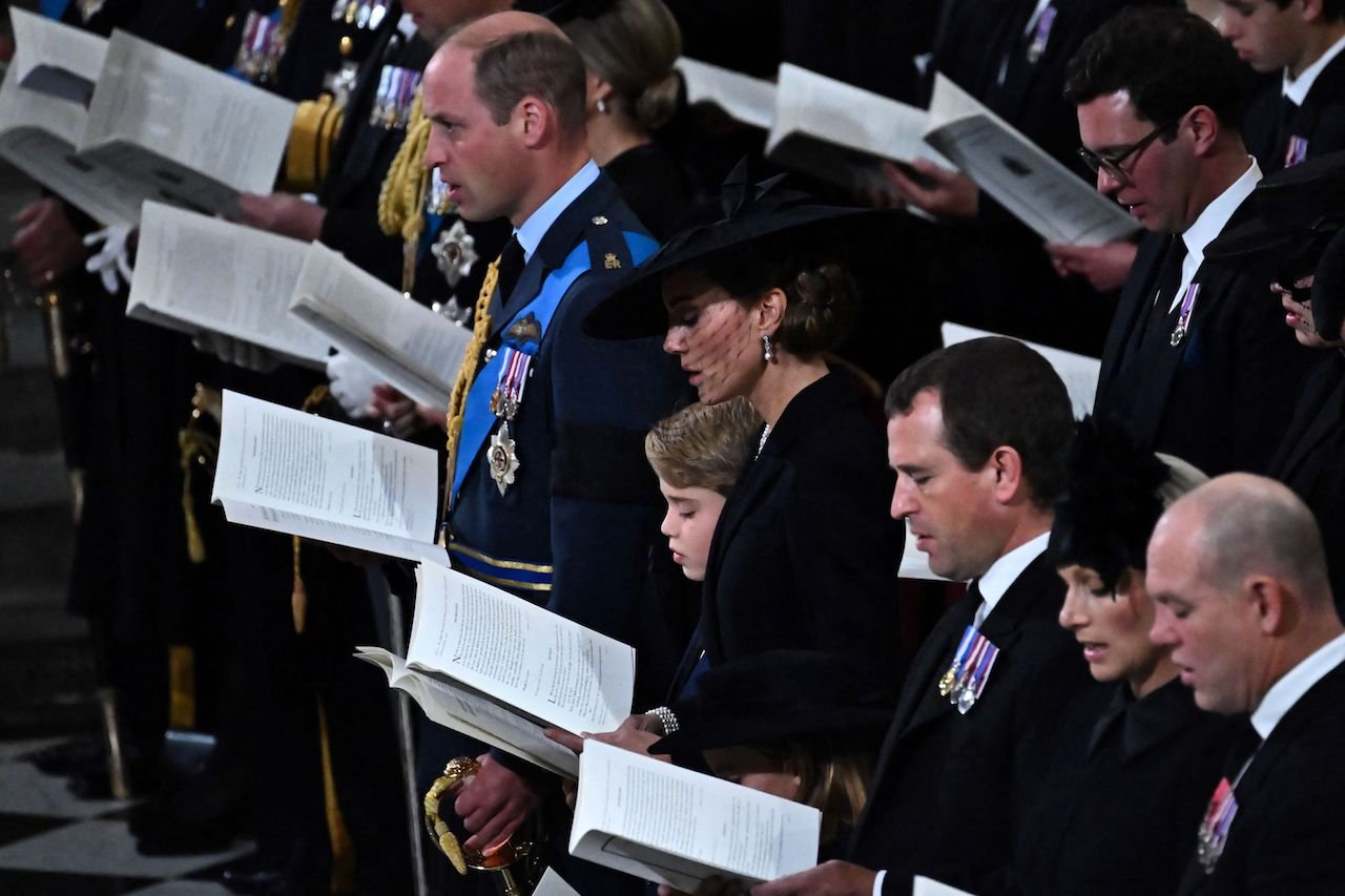 The Wales family (Kate, William, George and Charlotte) in the pews at the Queen's funeral.