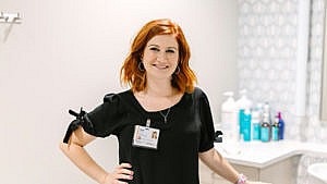 a hair stylist poses for a picture