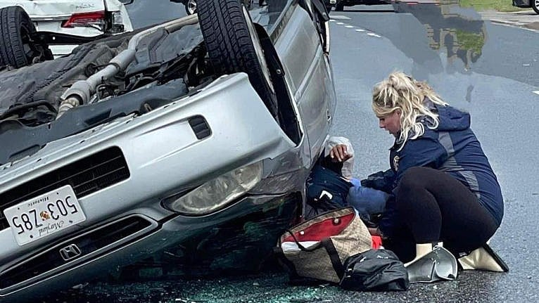 An image of Megan Warfield saving a car crash victim.