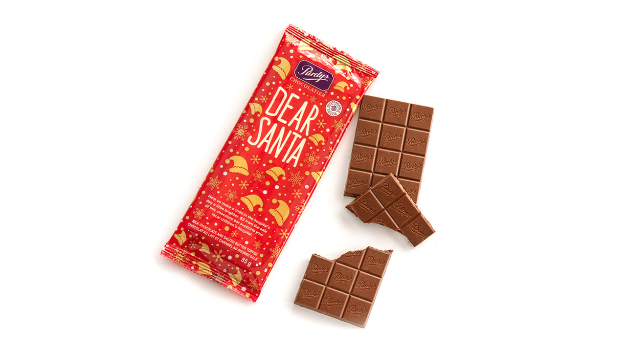 A chocolate bar with a red wrapper that says Dear Santa
